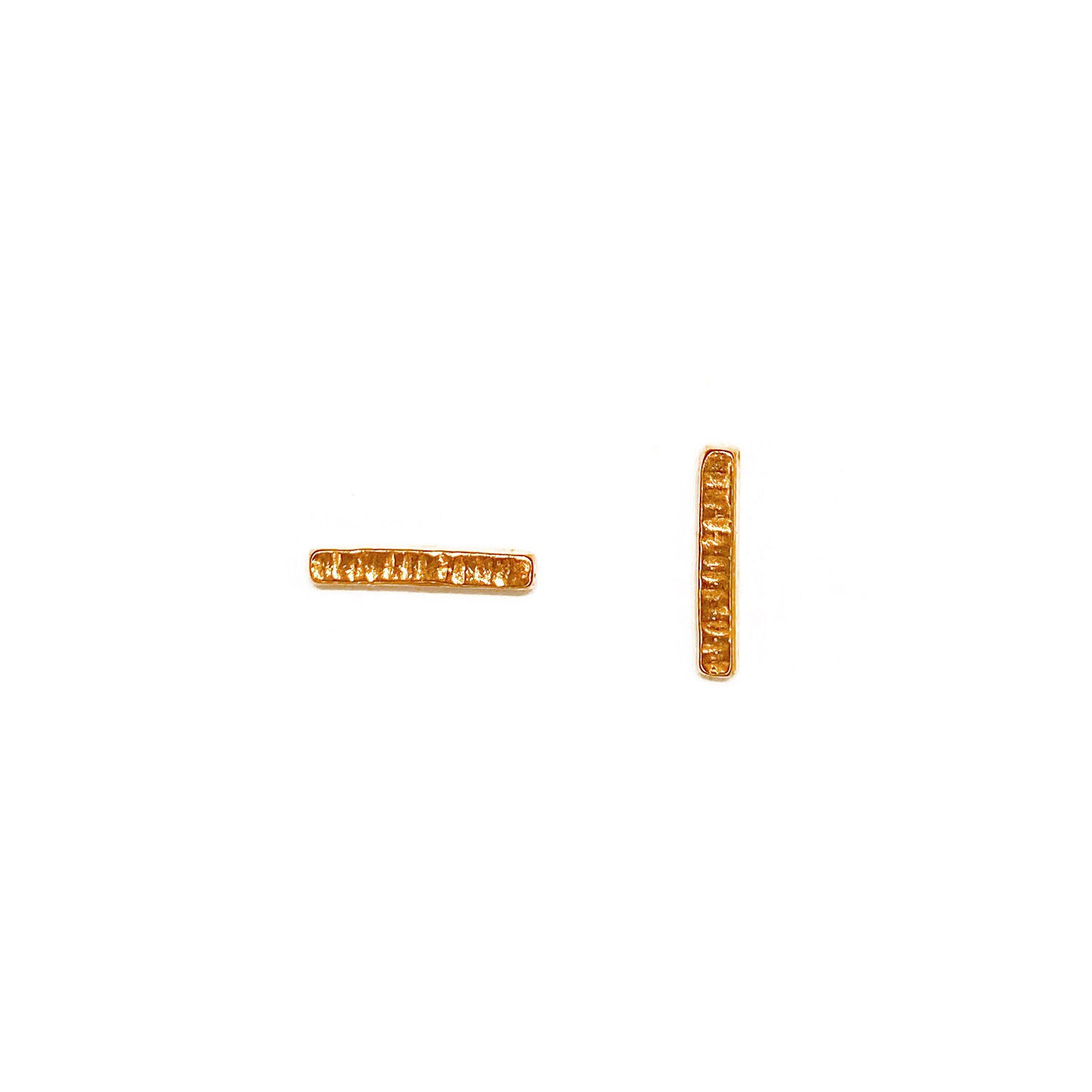 Small thin bar studs with line texture accross the short dimension photographed on a white background