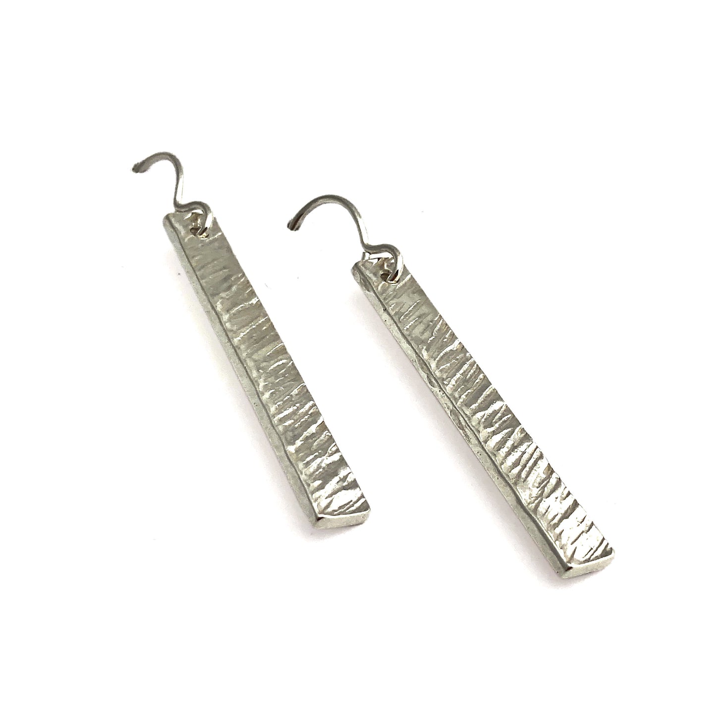Two silver vertical rectangular earrings with angled line texture laying flat