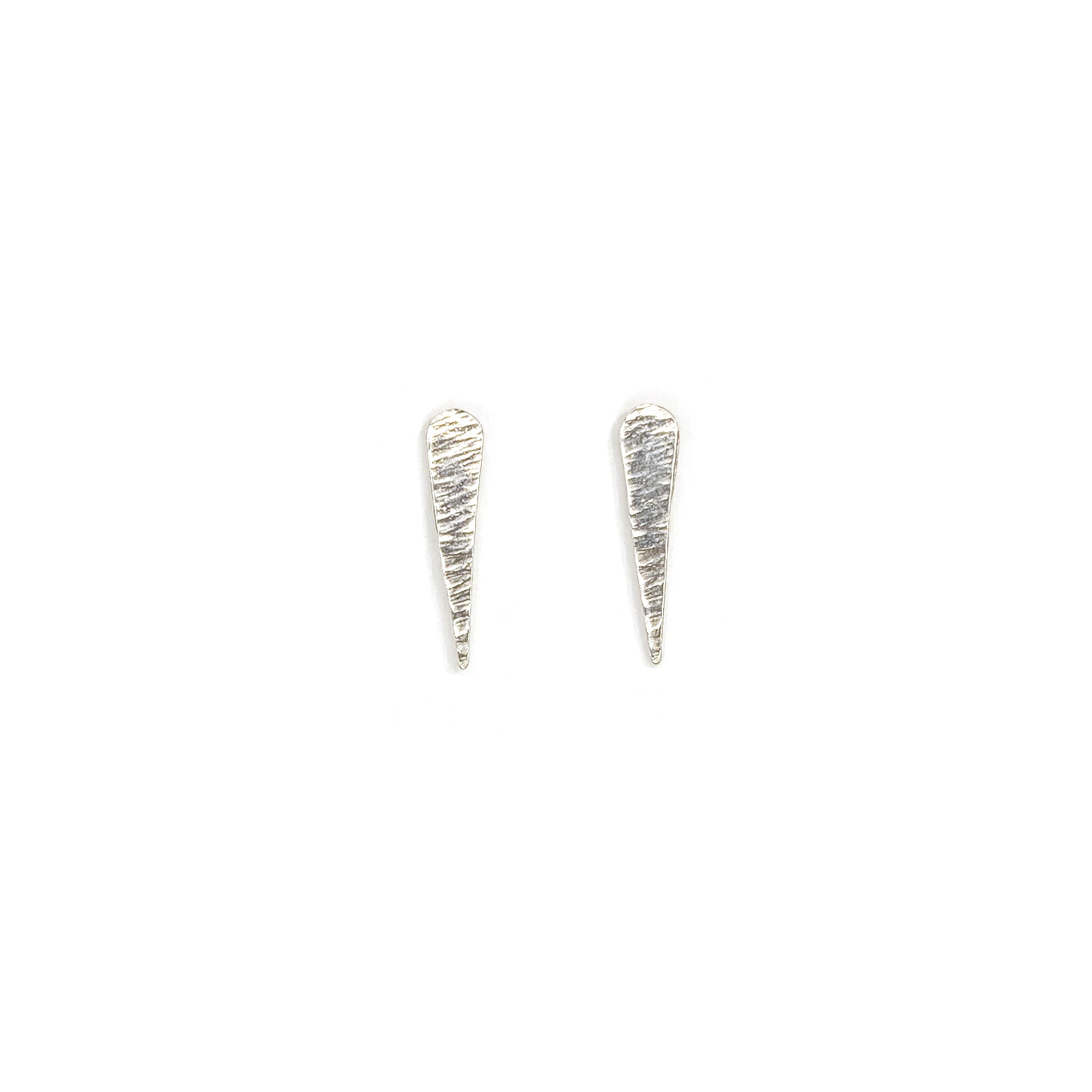 Silver, textured studs shaped like comets and their tails on a white background.