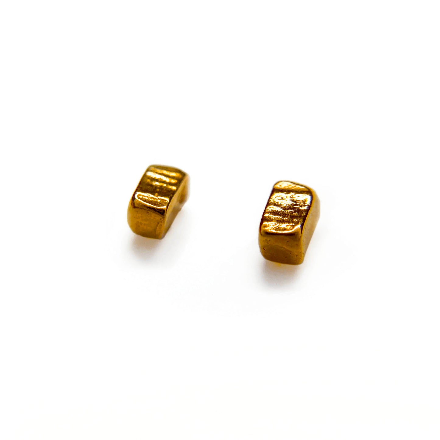 Two rose gold vermeil studs laid flat at an angle on a white background